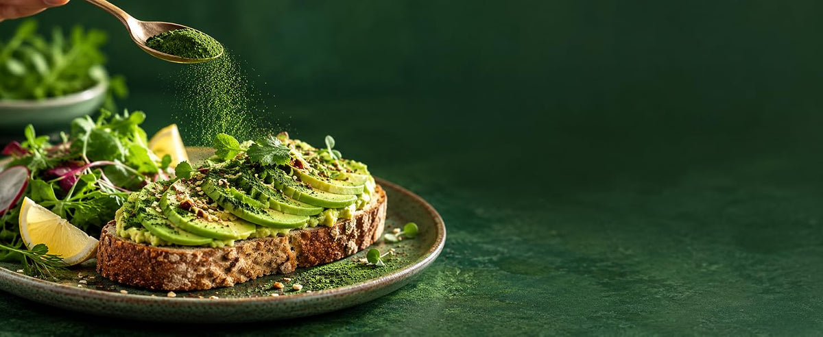 Chlorella en polvo espolvoreada sobre cremas, ensaladas y tostada de aguacate